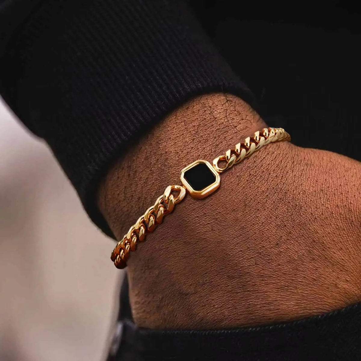 Gold chain bracelet with stone charm
